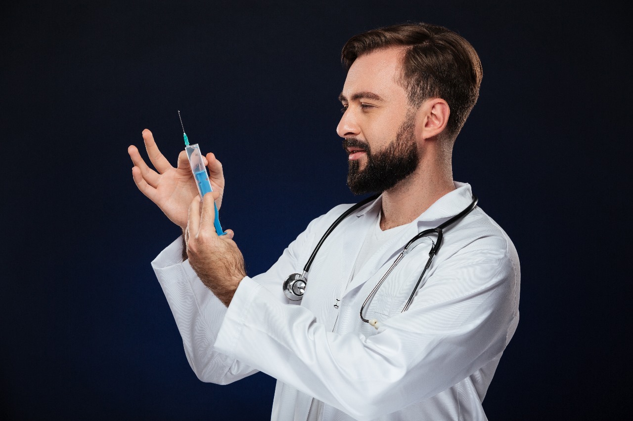 Sermorelin injection vials and syringe on a clinical surface