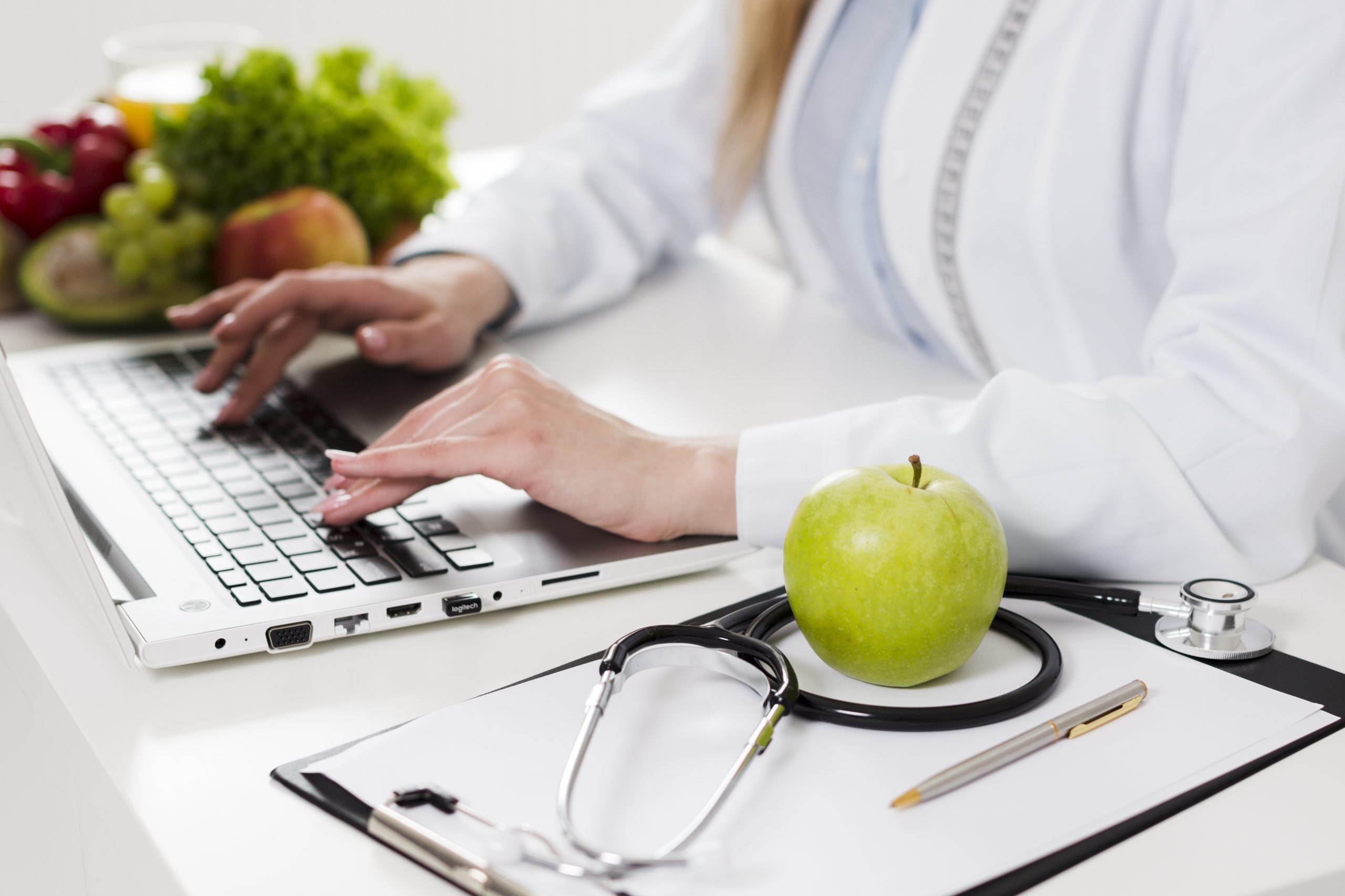 Female clinician reviewing a customized medical weight loss plan with healthy foods