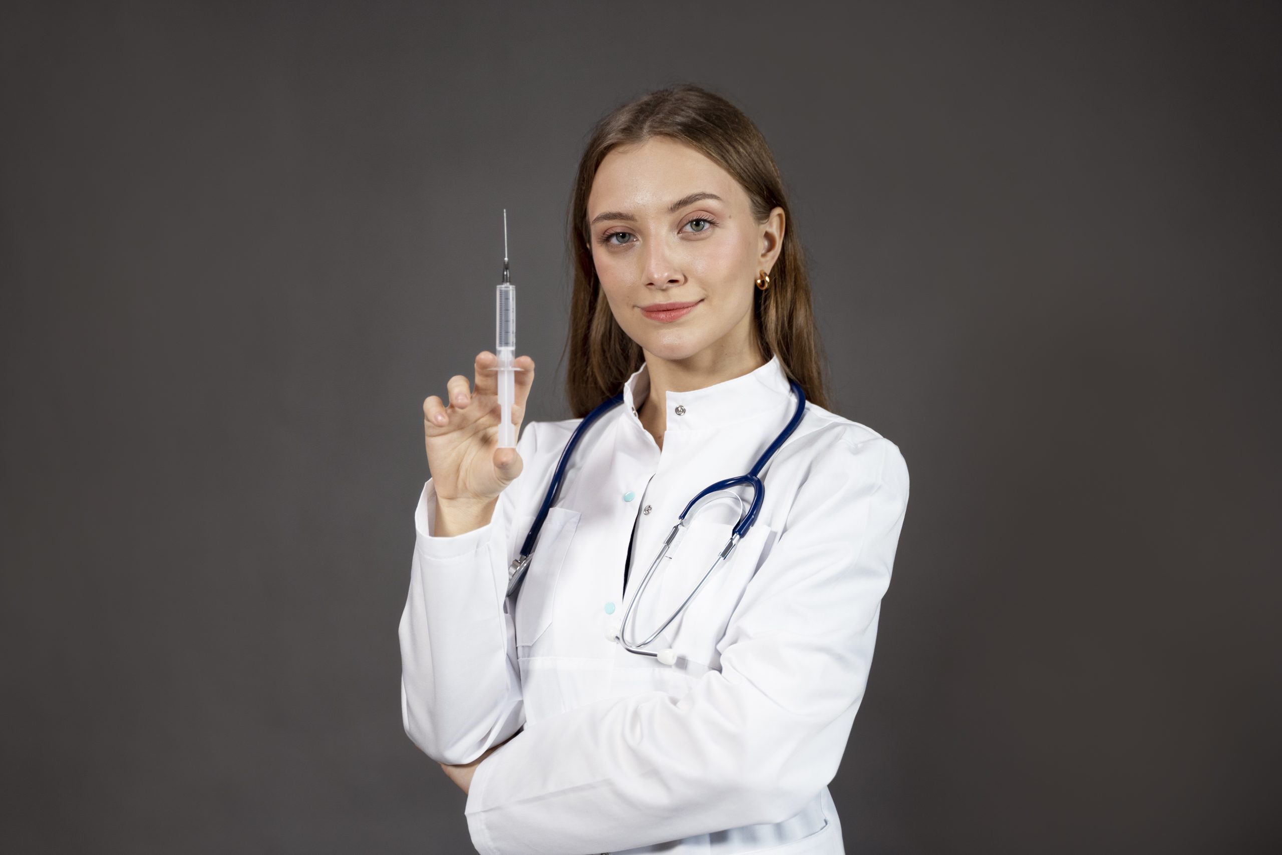 Smiling doctor holding a syringe for a weight loss injection