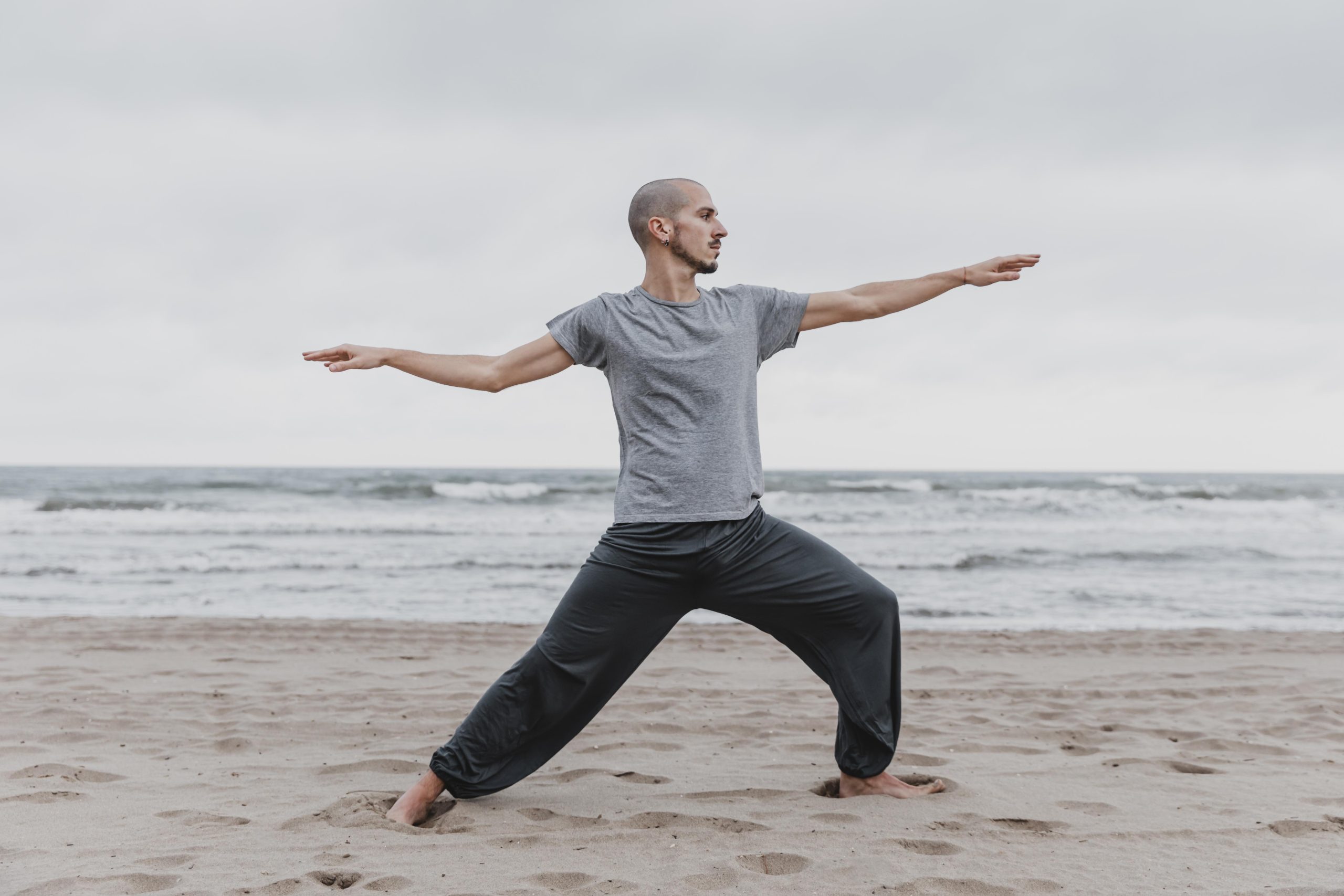Man practicing a yoga stretch outdoors
